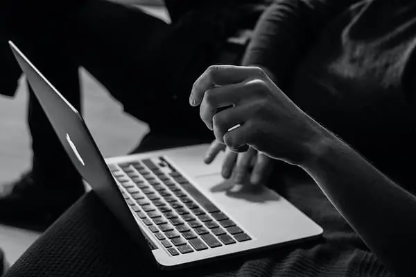 Internet providers in Haiti - grayscale photo of person using MacBook